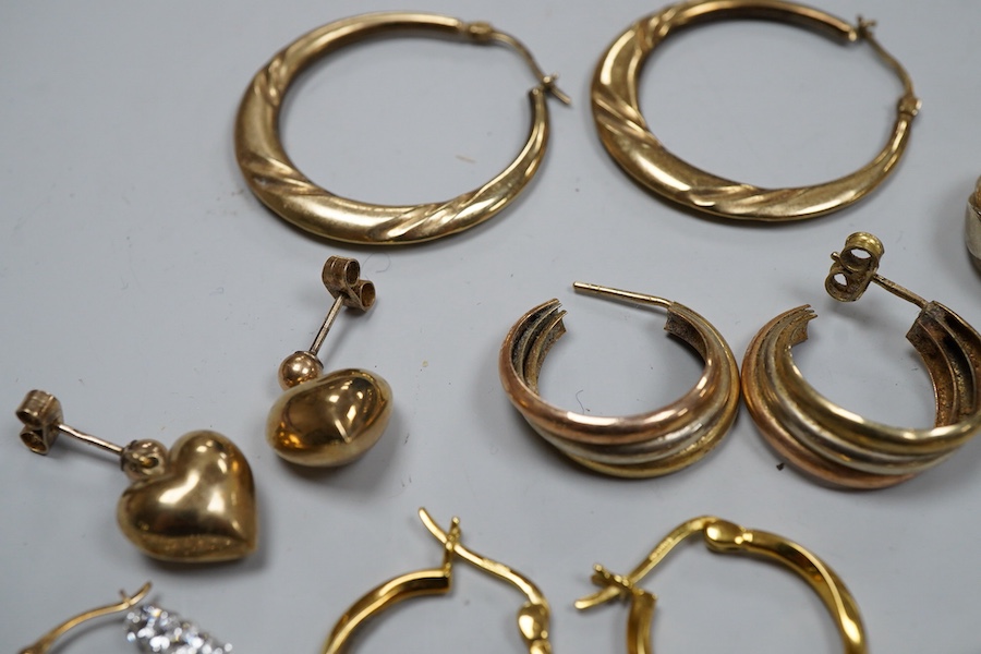 Nine pairs of earrings, comprising: seven hoop earrings, two of which set with pastes; and two pairs of drop earrings, six with British hallmarks for 9ct gold combined gross weight approximately 18 grams, three variously